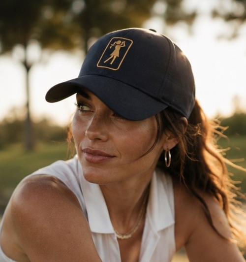 Woman wearing the Aurora Midnight golf hat outdoors at golden hour